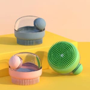 Three colorful silicone facial cleansing brushes on a pastel background.